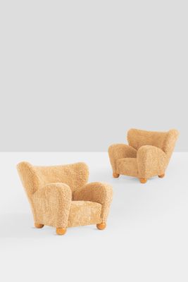 two chairs made out of wool and wood, one with a foot rest