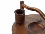 a wooden tea kettle with a wooden cup on it