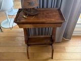 a small wooden table with a hat on top of it