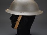 a silver helmet on a manne head on a grey background