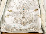 an image of a white robe with a blue and gold design