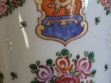 a vase with a picture of a lion and flowers on it