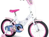 the girl ' s bike is pink and white with a minnie mouse design