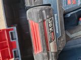a cordless drill in a toolbox with a red handle