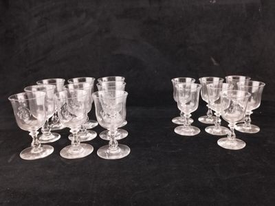 six verres à pied en verre transparent sont alignés sur une surface noire