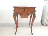 a small wooden table with a drawer on top of it