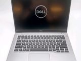 laptop computer with dell logo displayed on screen on white surface