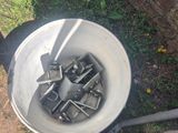 a bucket full of screws sitting on the side of the road