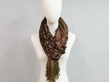 a mannequin with a scarf on it in front of a wall