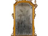 a mirror that has a gold frame on it