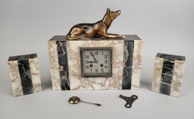 une horloge surmontée d'une statuette de chien
