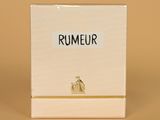 a close up of a box of perfume sitting on a table
