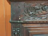 a close up of a carved wood door with a clock on it