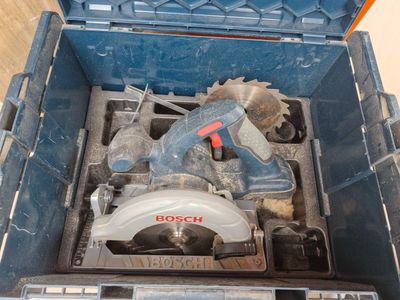 a blue tool box with a circular saw and a circular saw blade