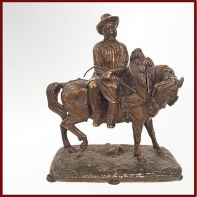 une statue en bronze représentant un homme à cheval