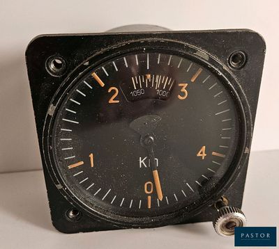 a black clock with a yellow face on a white table