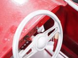 a red car with a steering wheel and a steering wheel
