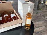 bottles of wine are sitting on a table next to a box of wine