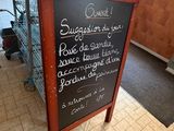 a chalk board with a menu on it in a restaurant
