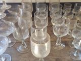 a lot of wine glasses sitting on a wooden table