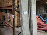 a large pile of pipes in a building with a lot of wood
