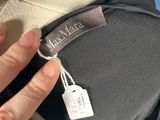 a person that is holding a bag with a tag on it
