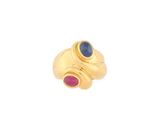 a close up of a gold ring with a blue and red stone
