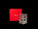an image of a small crystal vase sitting in front of a red box