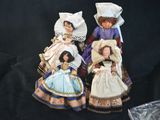 three dolls that are sitting next to each other on a black background