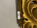 an antique gold plate with a heart on it on a white surface