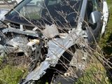 a car that has crashed into a tree in the grass