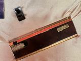 a box that has a lighter in it on a bed