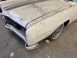 an old car that has been rusted and is sitting in a garage