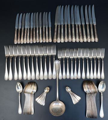 an assortment of silverware including forks and spoons on a table