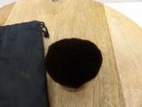 a black bag and a black ball on a wooden table