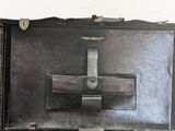 a black suitcase with a cross on it sitting on a table