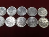 a close up of a bunch of silver coins on a table