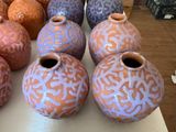 many different colored vases sitting on a table