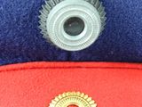 a close up of a hat with a pin on it