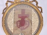 a picture of a picture of a cross in a gold frame