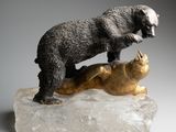 statue of a bear and a cat on a rock on a gray background