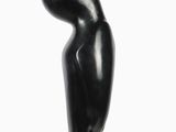 black sculpture of a woman ' s head on a black base