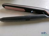 a black and pink hair straighten sitting on a table