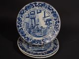 two blue and white plates sitting on top of each other