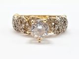a close up of a diamond ring on a white surface