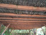 a wooden structure with a roof made of bamboo sticks