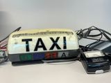 an image of a taxi sign and a car charger