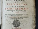 an old book with writing on it sitting on top of a table