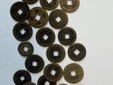 a lot of coins that are on a white surface