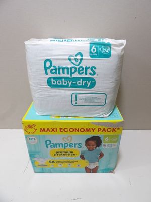 two boxes of baby diapers sitting on top of each other